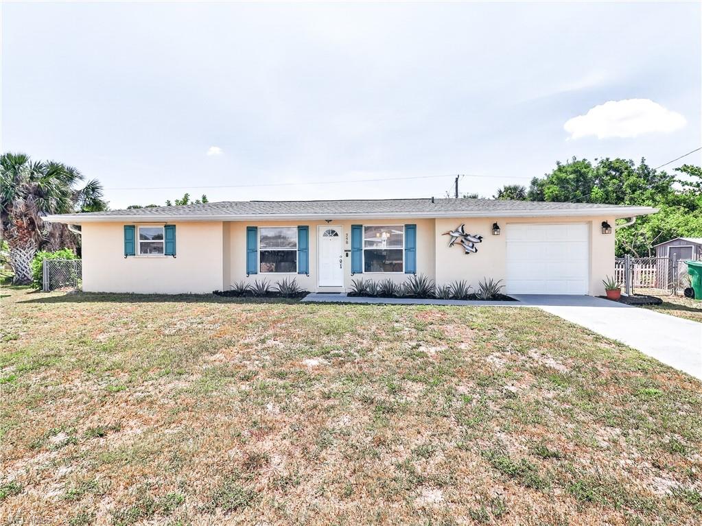 Stucco exterior with a single-car garage, white front door, and blue exterior window shutters