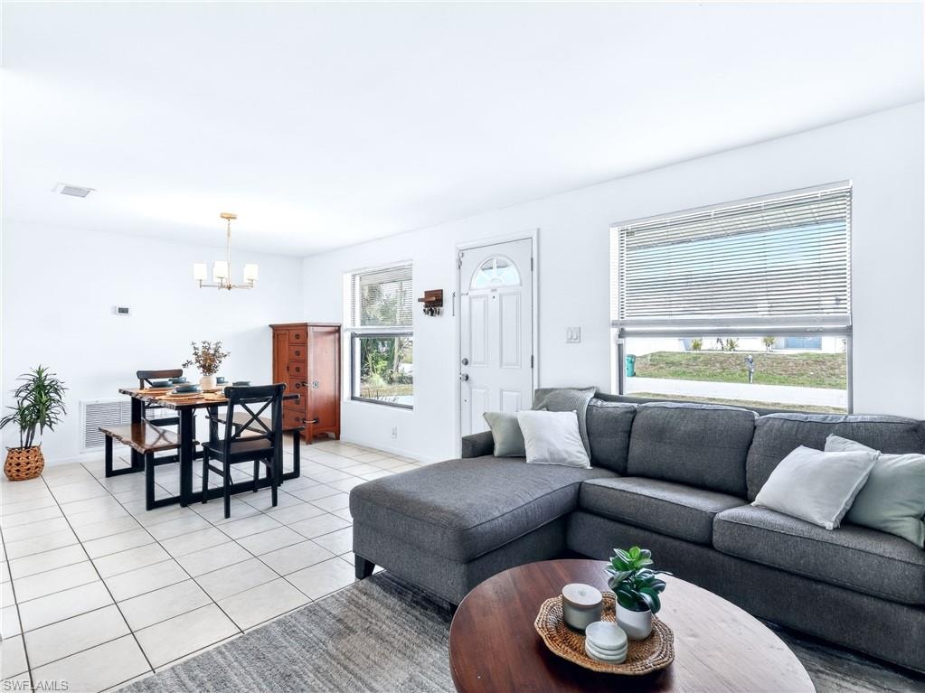 Open-concept living area with neutral tile flooring throughout