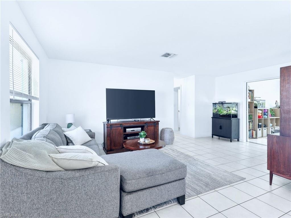 Bright living area featuring tile flooring and white walls