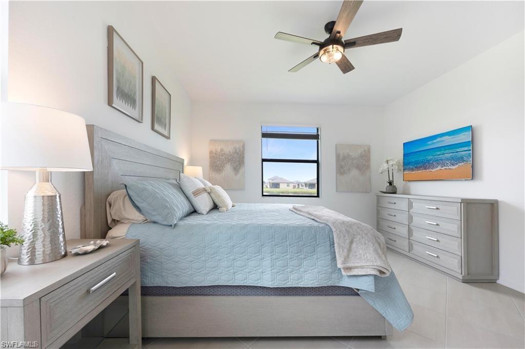 Bright bedroom featuring light-toned walls and tile flooring