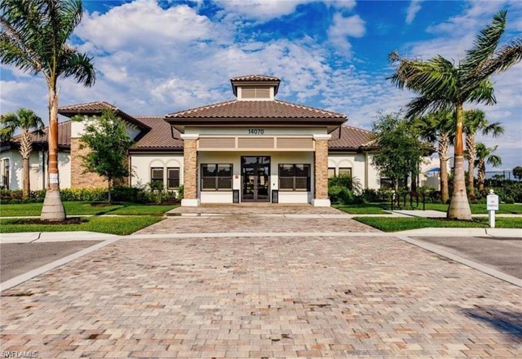 Mediterranean-style building featuring a tiled roof and stucco exterior