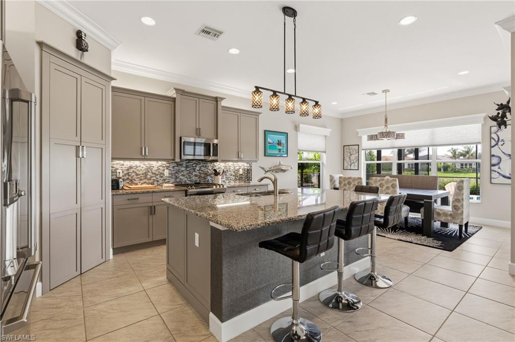 Open kitchen with island, plenty of seating and lots of cabinet space.