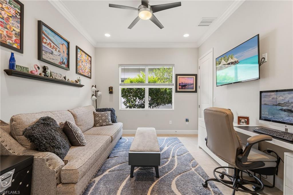 Spacious den/ 3rd bedroom, with barn style door, walk-in closet, crown molding, tile flooring.