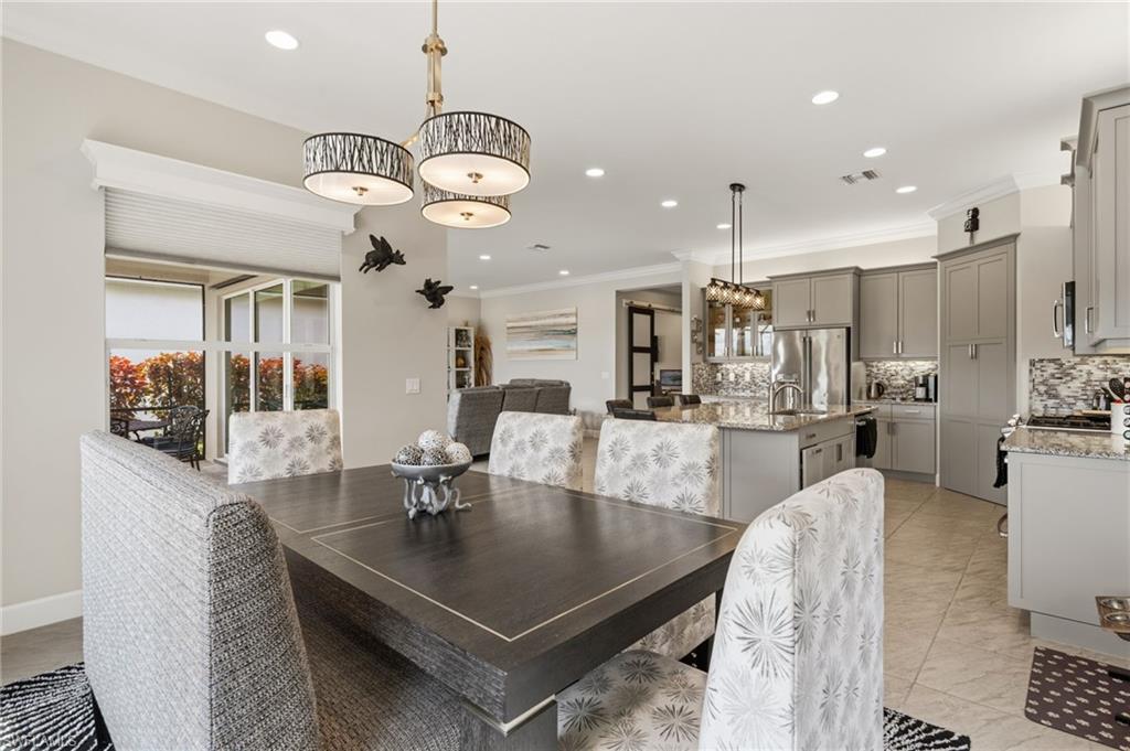Open area dining room with ease of access to kitchen, designer lighting.