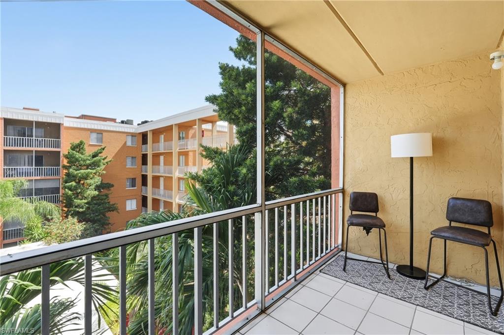 Screened-in balcony with white tile flooring and textured exterior wall finish