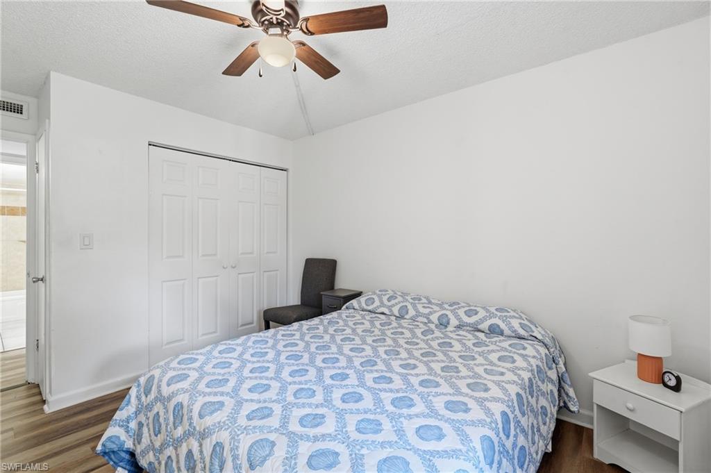2nd Bedroom featuring wood-finish flooring, a ceiling fan, and white bi-fold closet doors