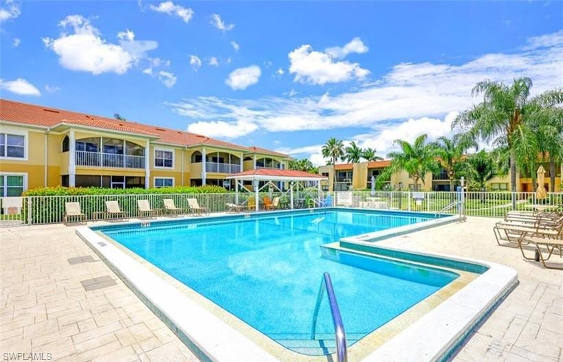 Resort-style swimming pool with integrated spa, surrounded by paver patio decking
