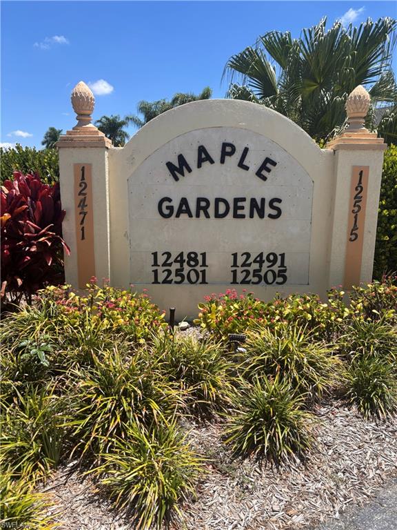 "Maple Gardens" community signage featuring numerical street addresses and decorative finials