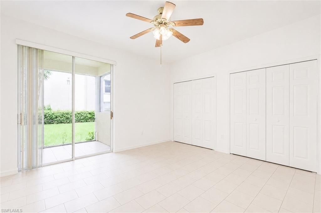 Light-toned tile flooring extends through this room, featuring a ceiling fan with integrated lighting