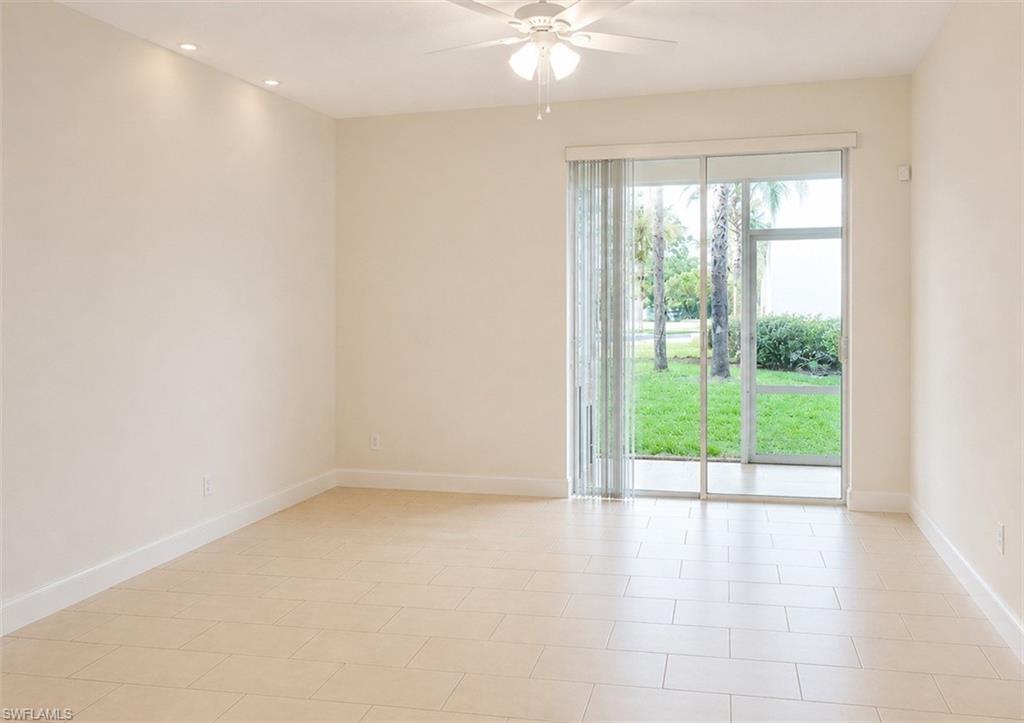 Expansive room featuring tile flooring, a ceiling fan with integrated lighting, and recessed ceiling lighting
