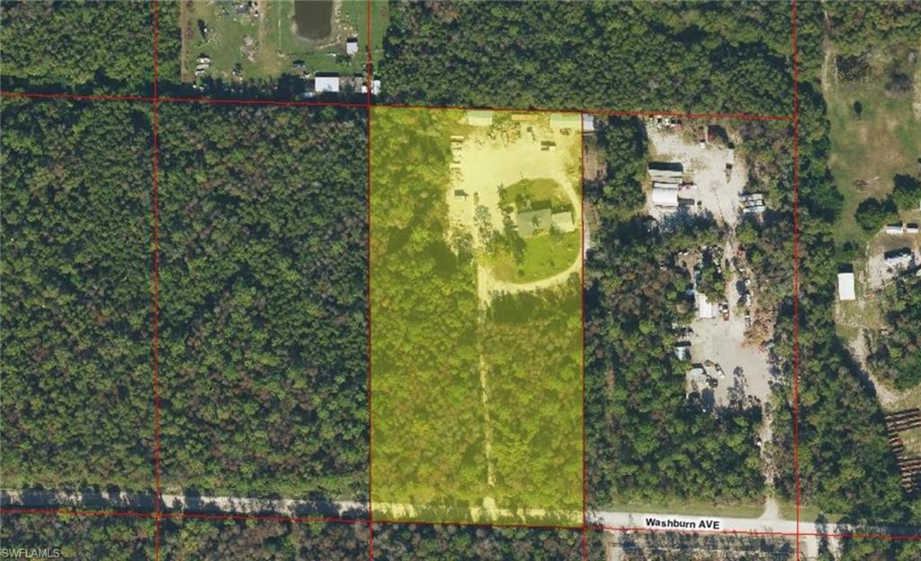 Aerial view showcasing a rectangular parcel with a cleared section, partially covered in dense tree canopy