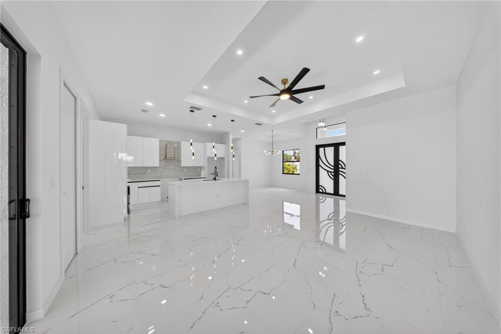 Open-concept living space with large format porcelain tile flooring