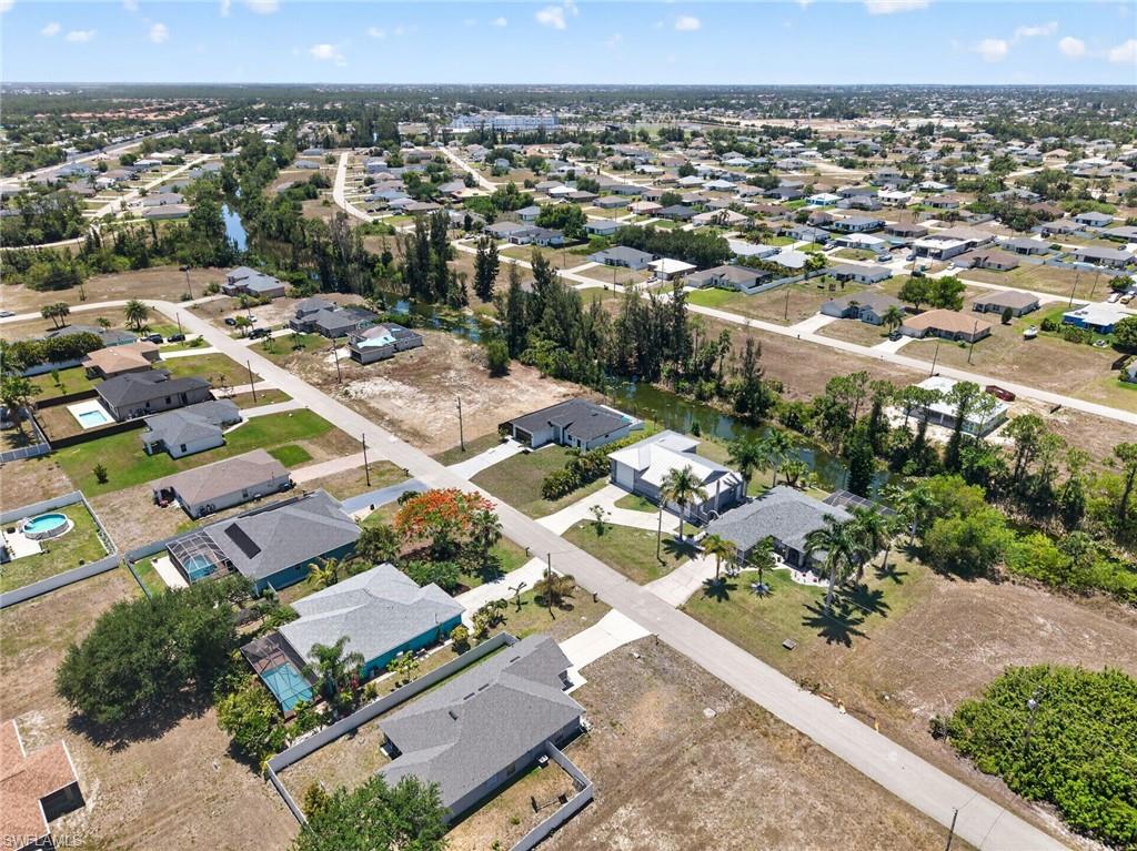 Residential area featuring canals, paved roads, and a mix of developed and undeveloped lots