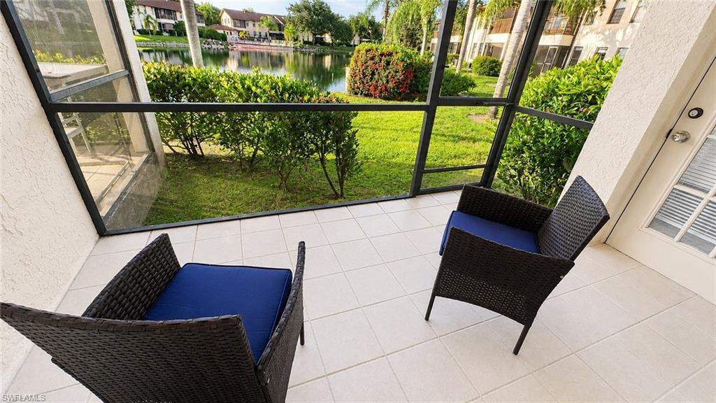 Screened porch featuring large format tile flooring and white stucco walls