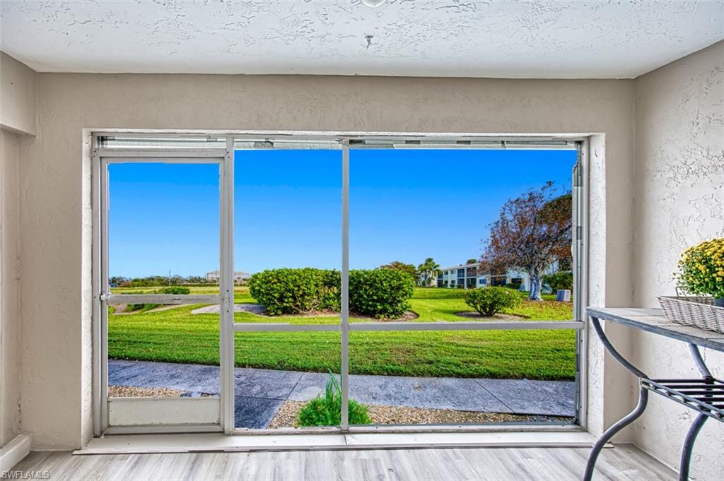 Screened Lanai Garden View. Walk out patio. New flooring.