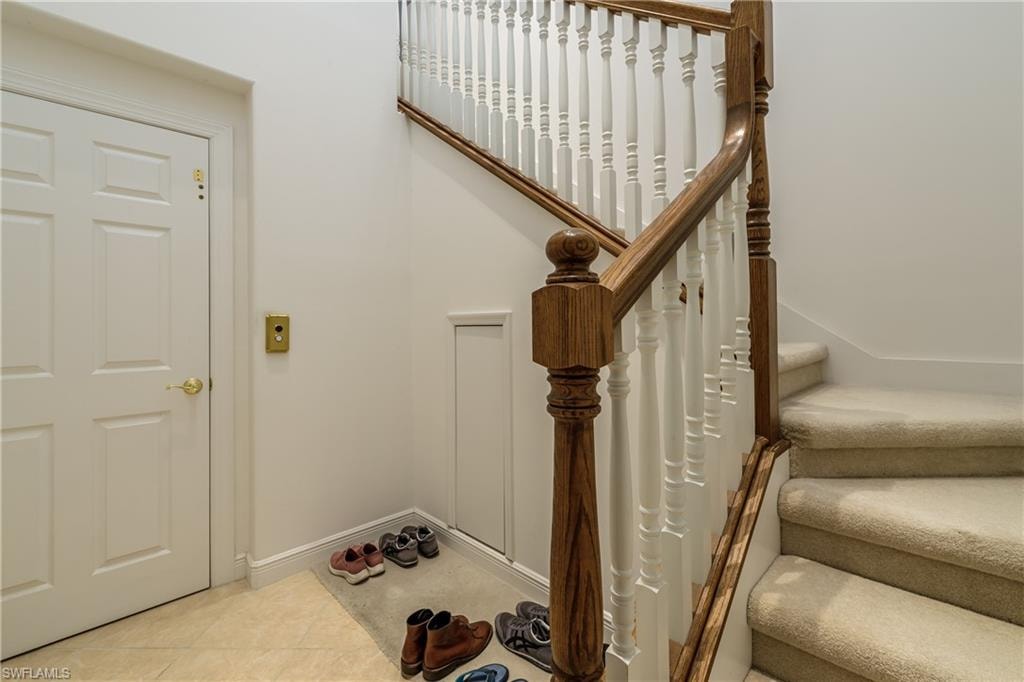 Staircase featuring tile patterned flooring