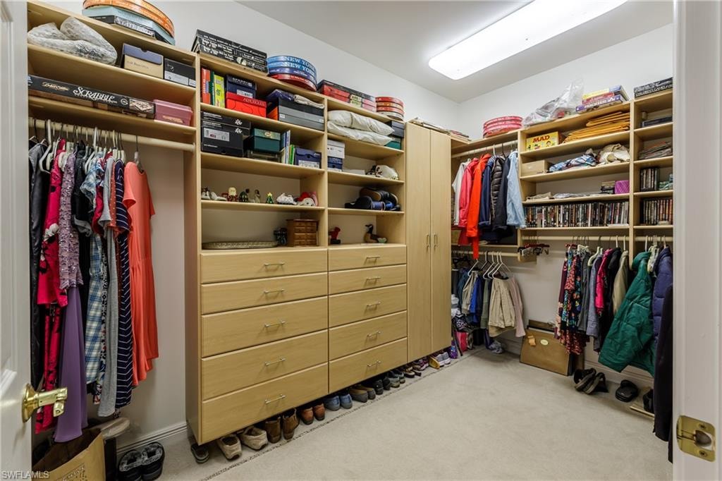 Walk in closet featuring light carpet