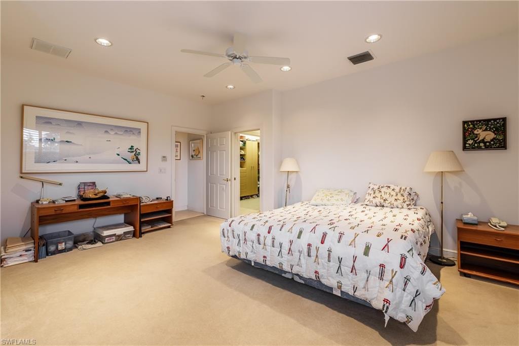 Carpeted bedroom with ceiling fan
