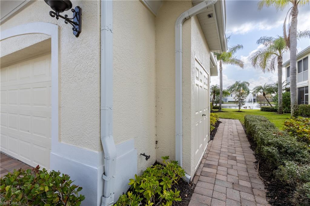 View of property exterior with a garage and stucco siding