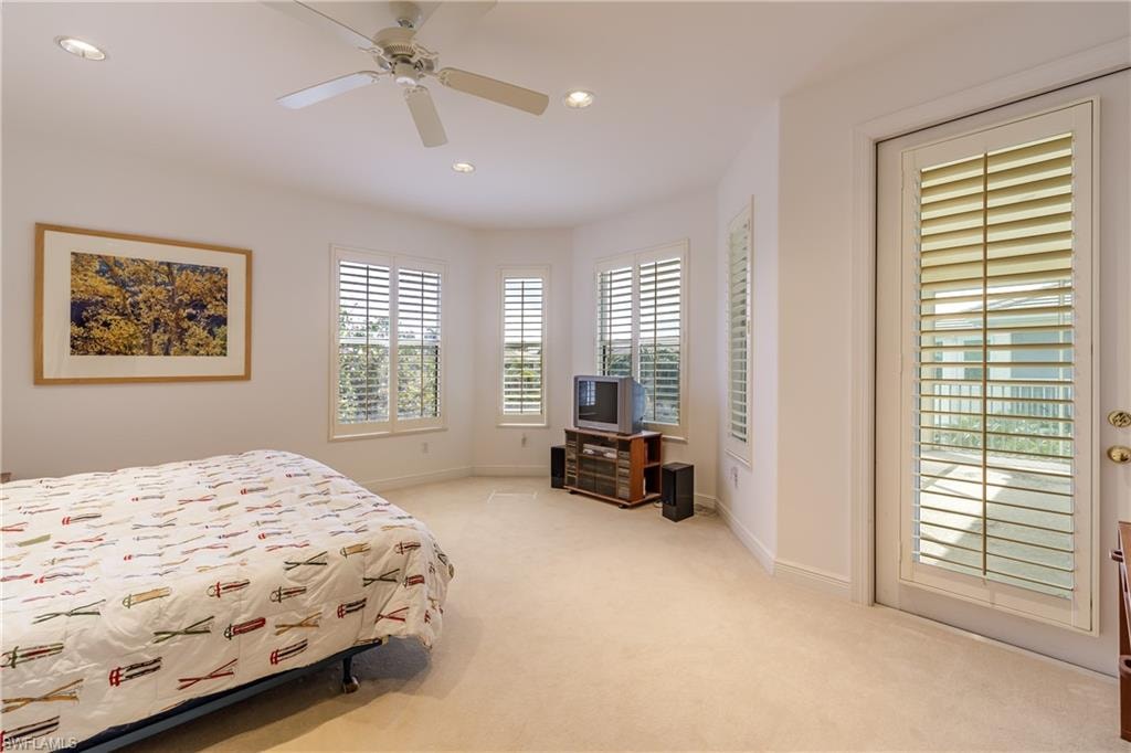 Bedroom with light colored carpet and ceiling fan
