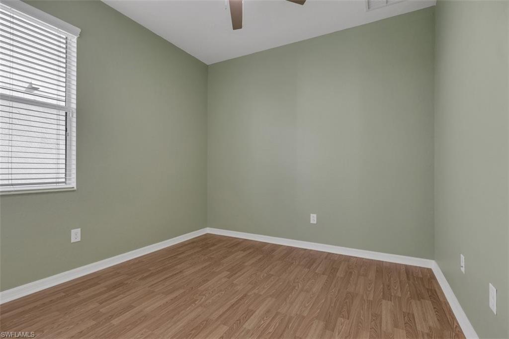Empty room with light wood-style flooring and ceiling fan