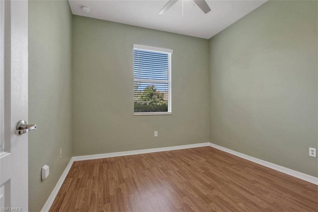 Unfurnished room with wood finished floors and ceiling fan