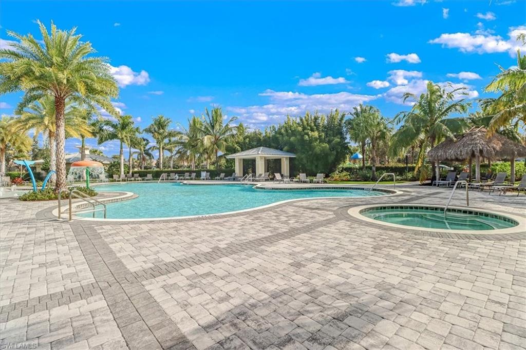 Community pool featuring a gazebo, a hot tub, and a patio area