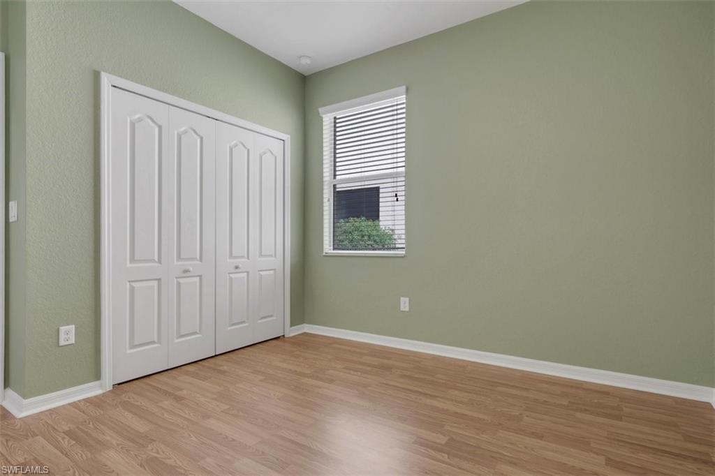 Unfurnished bedroom featuring light wood finished floors and a closet