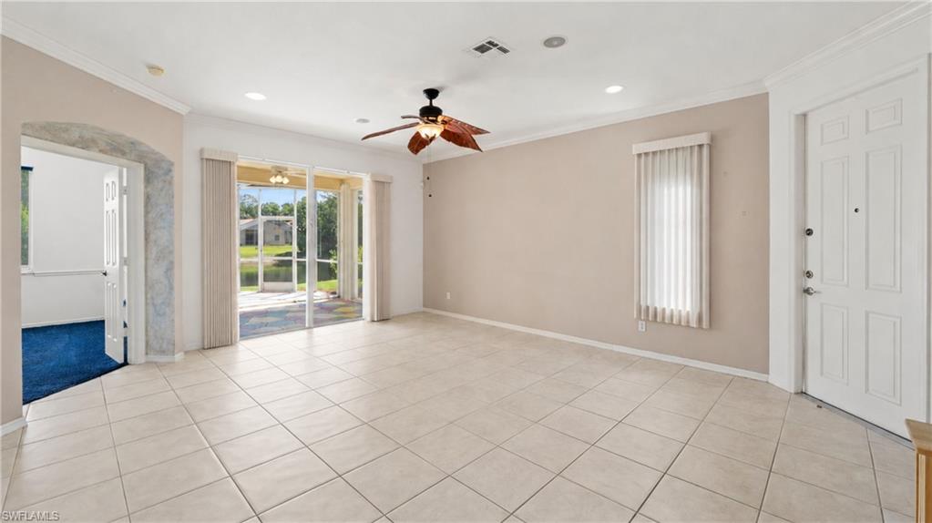Spacious interior with tile flooring and a ceiling fan