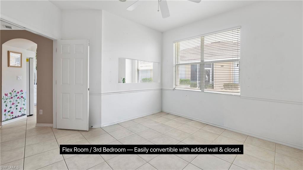 Versatile room featuring tile flooring, a large window with horizontal blinds, and a ceiling fan