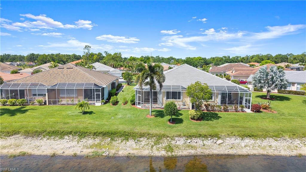 Expansive screened lanai extending across the rear facade, offering an outdoor living area