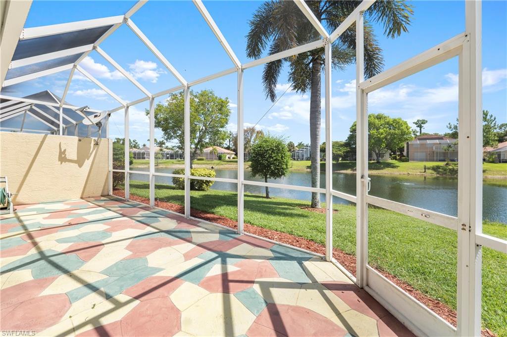 Screened lanai featuring patterned paver flooring and direct water frontage