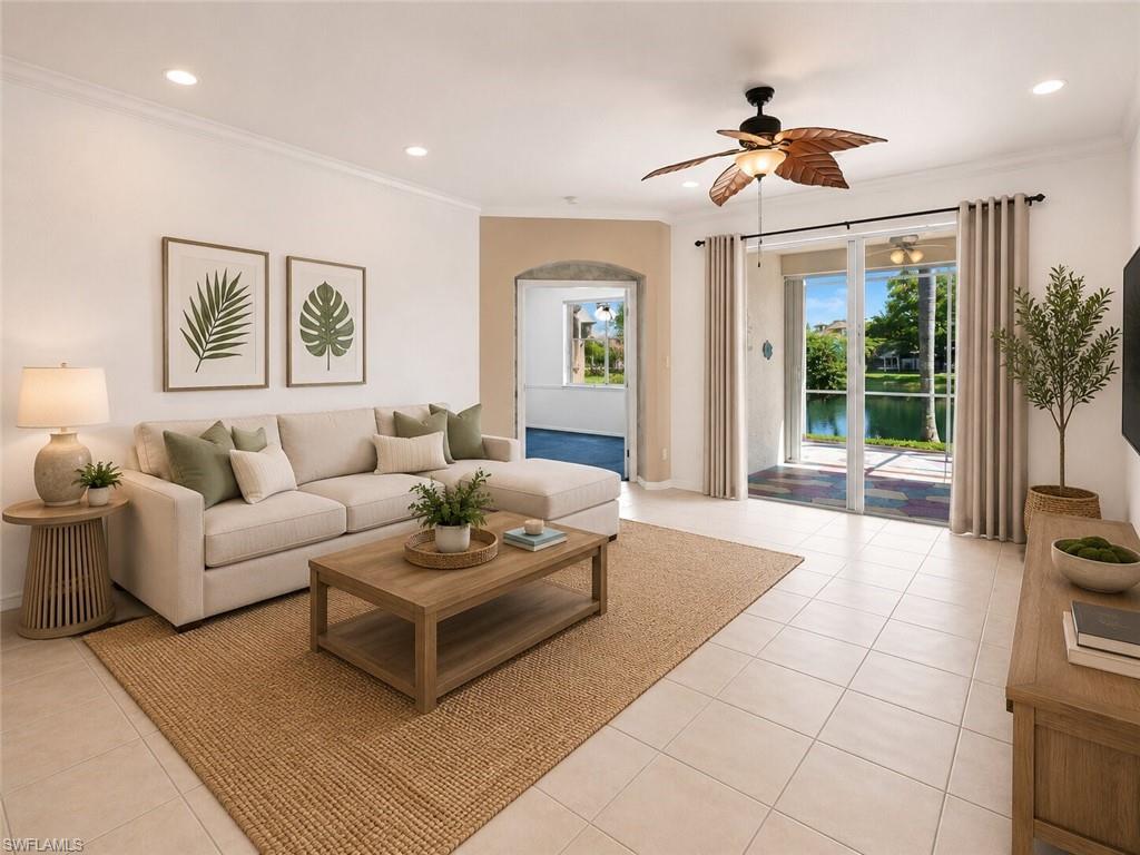 Spacious living area featuring neutral tile flooring, recessed lighting, and a ceiling fan