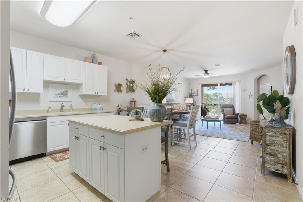 The kitchen is bright and open, with plenty of natural light and cabinet space.