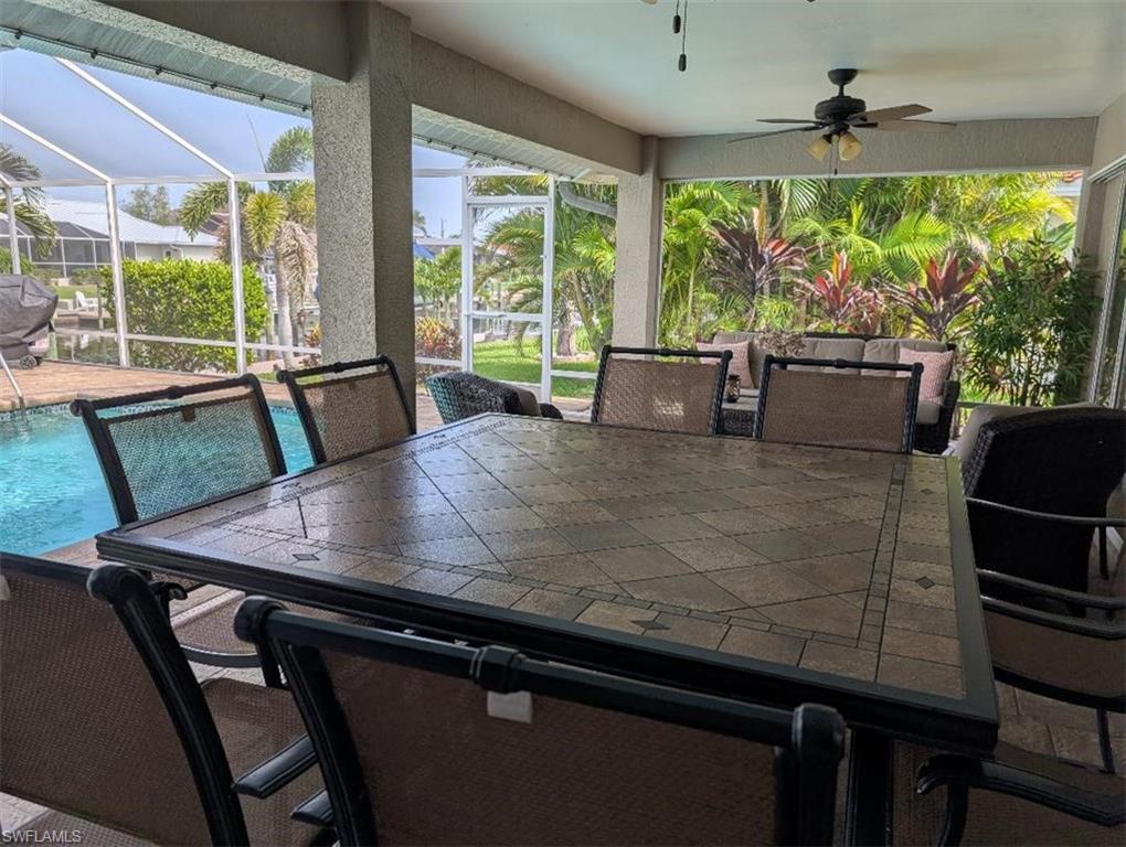 Sunroom with ceiling fan and outdoor dining area