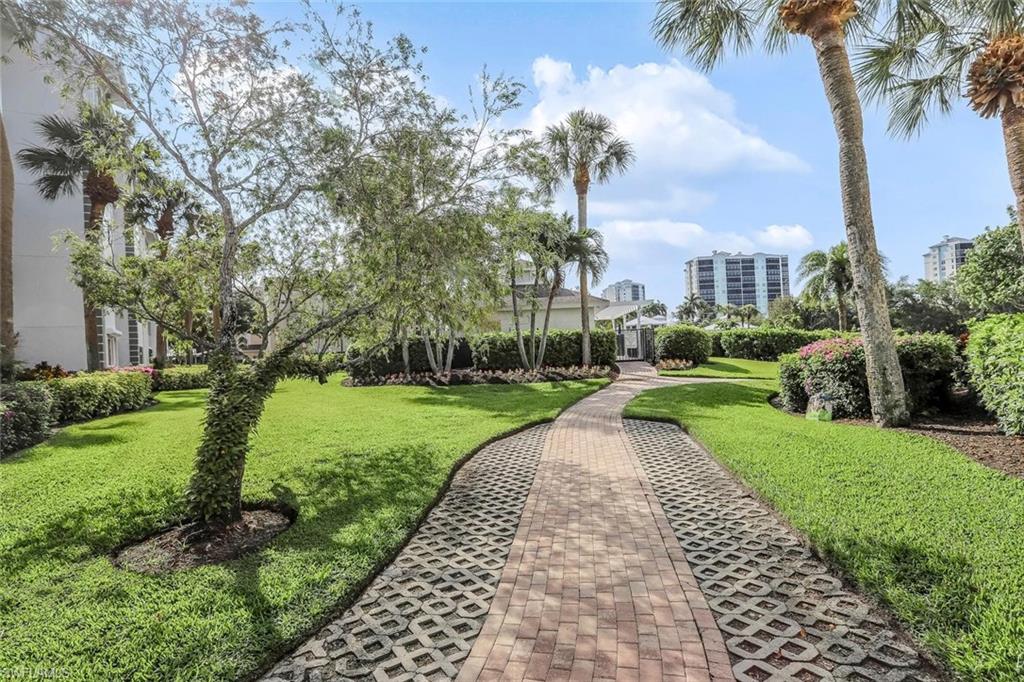 Landscaped pathway featuring a paver and grid design