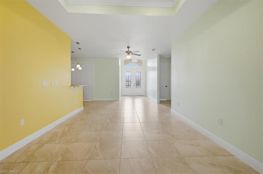 Spacious interior with large format tile flooring and tray ceiling