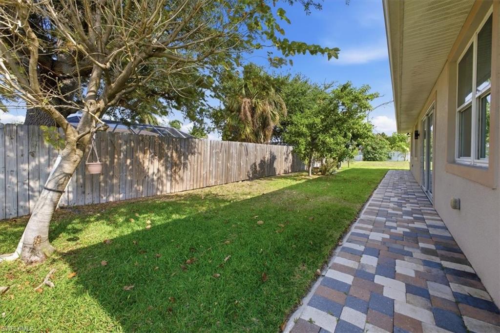 Expansive lawn area bordered by a wood fence