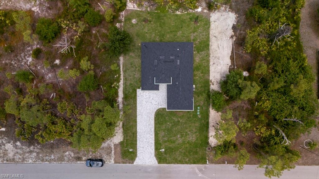 Single-story residence with a dark shingle roof and a light-colored paver driveway