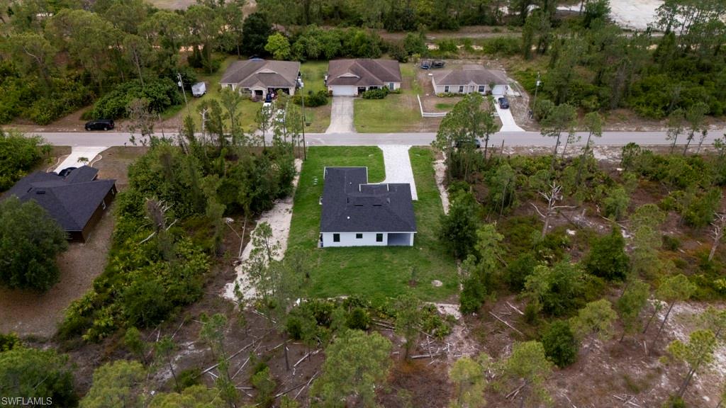 Newly constructed single-story residence featuring a dark shingle roof and white exterior