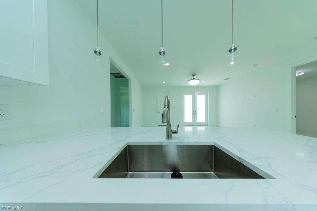 Waterfall edge countertop with integrated stainless steel sink and a single-handle faucet