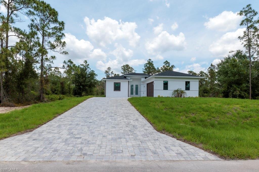 Modern white stucco exterior with a dark roof and contrasting dark window frames