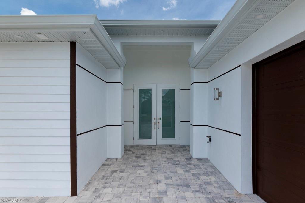 Modern architectural facade featuring white siding and dark trim accents