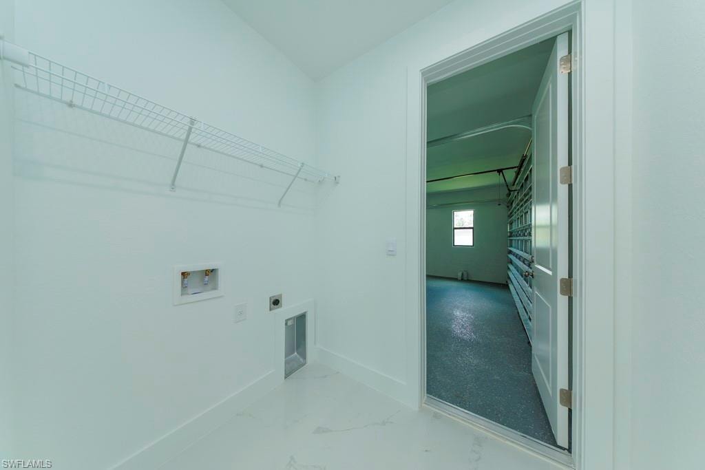 Utility room featuring white wire shelving and a washer/dryer hookup