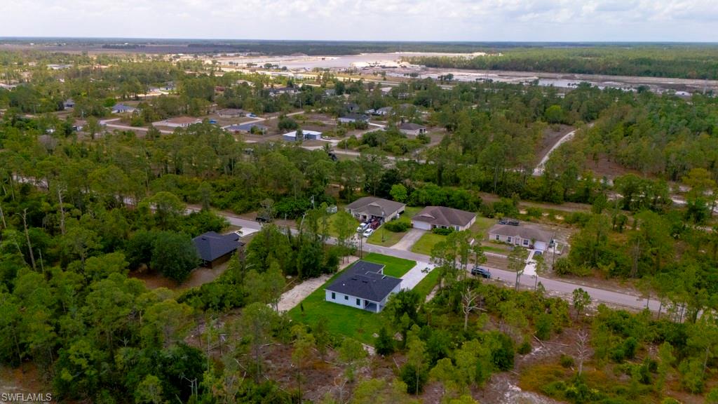 Aerial perspective showcasing a residential area amidst extensive natural landscaping