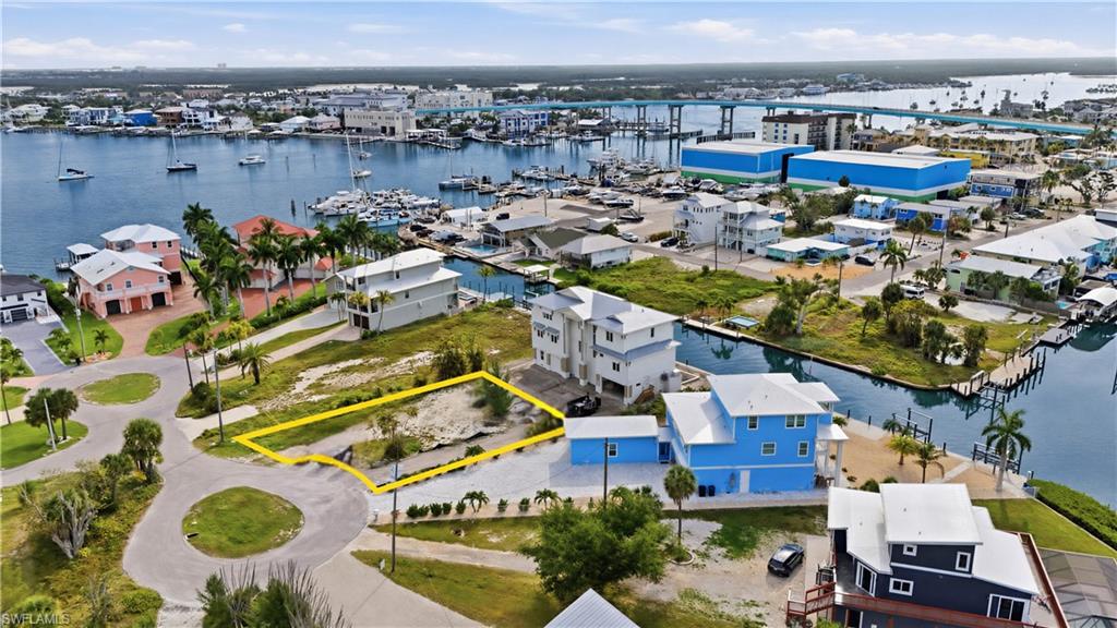 Aerial view of lot surrounded by bay- virtually enhanced
