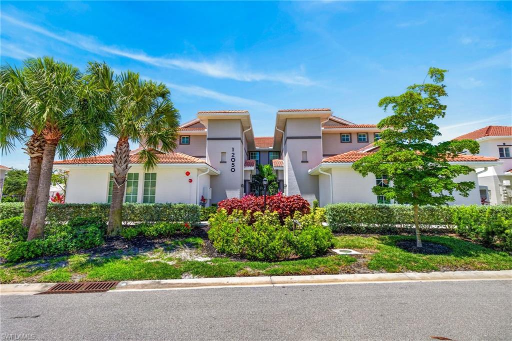 Mediterranean-style property with a red tile roof and stucco exterior