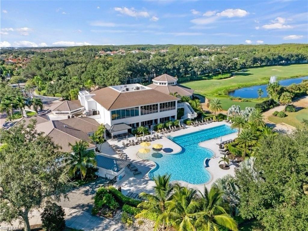 The Club at Gateway Expansive resort-style clubhouse featuring a custom-shaped swimming pool, surrounding lounge areas, and multiple structures under pitched roofs