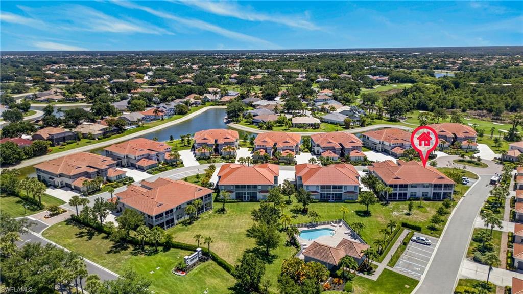 Aerial view of a residential community featuring multiple multi-story buildings with red tile roofs