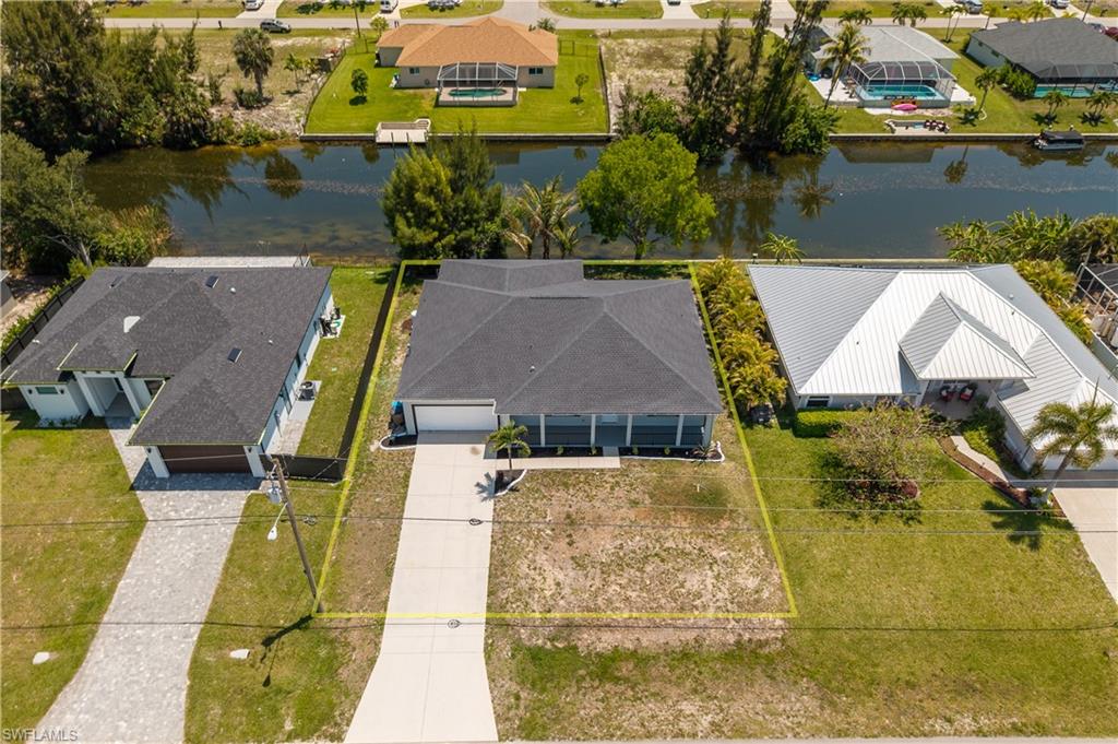Contemporary-style property featuring a dark shingle roof and a concrete driveway